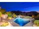 Backyard pool at twilight with built-in water features and serene desert mountain views at 24350 N Whispering Ridge Way # 22, Scottsdale, AZ 85255