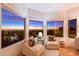 Sitting room with city views, two chaise lounges, and three large picture windows at 24350 N Whispering Ridge Way # 22, Scottsdale, AZ 85255