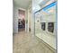 Bathroom with a shower behind clear glass doors and a walk-in closet at 24552 W Hilton Ave, Buckeye, AZ 85326