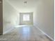 Bright bedroom features neutral walls and tiled floor providing a clean and modern aesthetic at 24552 W Hilton Ave, Buckeye, AZ 85326