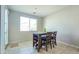 Cozy dining area with modern table set and natural light filtering through the window at 24552 W Hilton Ave, Buckeye, AZ 85326