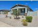 Charming single-story home featuring desert landscaping, a covered porch, and a neutral color palette at 24552 W Hilton Ave, Buckeye, AZ 85326