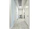Bright hallway with neutral walls and floors, featuring access to multiple rooms and ample natural light at 24552 W Hilton Ave, Buckeye, AZ 85326