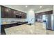 Beautiful kitchen island featuring granite countertops and stainless steel appliances with tiled flooring at 24552 W Hilton Ave, Buckeye, AZ 85326