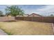 Large backyard with privacy wall, tree and hardscape at 2889 S 161St Dr, Goodyear, AZ 85338