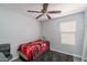 This carpeted bedroom features neutral walls, a window with blinds and a ceiling fan for optimal comfort at 2889 S 161St Dr, Goodyear, AZ 85338