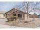 Charming single-story home with desert landscaping, well-manicured lawn, and attached garage at 2889 S 161St Dr, Goodyear, AZ 85338
