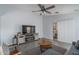 Bright living room with tile floors, large windows, and a ceiling fan for added comfort at 2889 S 161St Dr, Goodyear, AZ 85338