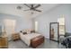 Serene primary bedroom featuring a ceiling fan, ample natural light, and wood-look tile flooring at 2889 S 161St Dr, Goodyear, AZ 85338