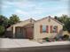 Charming single-story home with a tile roof, two-car garage, and desert landscaping at 314 S San Fernando Ln, Casa Grande, AZ 85194