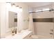 Bright bathroom featuring white vanity and a shower over tub with hexagon tile accent wall at 3147 W Phelps Rd, Phoenix, AZ 85053