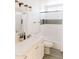 Clean bathroom with a white vanity, tub/shower combo with hex tile accents and gray wood look flooring at 3147 W Phelps Rd, Phoenix, AZ 85053