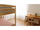 This bedroom includes a wooden bunk bed, wood floors, a desk, and a window with natural light at 3147 W Phelps Rd, Phoenix, AZ 85053