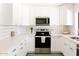 Bright white kitchen with stainless steel appliances, subway tile backsplash, and ample countertop space at 3147 W Phelps Rd, Phoenix, AZ 85053