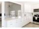 Bright kitchen has white cabinets, stainless steel appliances, and bar counter open to the living area at 3147 W Phelps Rd, Phoenix, AZ 85053