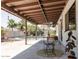 Outdoor covered patio features table with chairs and view of backyard swimming pool at 3147 W Phelps Rd, Phoenix, AZ 85053