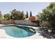 Backyard swimming pool features privacy block wall, mature landscaping and nearby barn at 3147 W Phelps Rd, Phoenix, AZ 85053