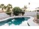 Refreshing backyard pool surrounded by lush greenery and a privacy fence for relaxation at 3147 W Phelps Rd, Phoenix, AZ 85053