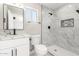 Bathroom featuring marble countertop, white vanity, toilet, window, and white marble tiled shower at 3249 E Nisbet Rd, Phoenix, AZ 85032