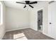 Bedroom features carpet, ceiling fan, window, and adjacent bathroom with shower and toilet at 3249 E Nisbet Rd, Phoenix, AZ 85032