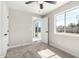 Bedroom boasts neutral carpet, white paint, window overlooking the backyard, and sliding glass doors at 3249 E Nisbet Rd, Phoenix, AZ 85032