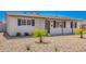 Charming single-story home featuring desert landscaping, covered entryway, and dark shuttered windows at 3249 E Nisbet Rd, Phoenix, AZ 85032