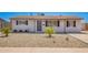 Charming single-story home featuring a desert landscape, covered entryway, and dark shuttered windows at 3249 E Nisbet Rd, Phoenix, AZ 85032