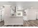 Modern kitchen featuring white cabinetry, stainless steel appliances, marble countertops, and wood floors at 3249 E Nisbet Rd, Phoenix, AZ 85032