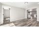 Spacious living room boasts grey wood floors, neutral paint, and ample natural light from adjacent rooms at 3249 E Nisbet Rd, Phoenix, AZ 85032