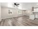 Bright living room featuring wood floors, neutral walls, and a modern ceiling fan at 3249 E Nisbet Rd, Phoenix, AZ 85032
