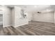Spacious open-plan living room featuring wood floors, neutral walls, and a modern kitchen at 3249 E Nisbet Rd, Phoenix, AZ 85032