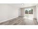 Bright room with light grey wood floors, neutral paint, and sliding glass doors to the backyard at 3249 E Nisbet Rd, Phoenix, AZ 85032