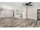 Spacious living room featuring wood floors, neutral walls, ceiling fan, and an open floor plan at 3249 E Nisbet Rd, Phoenix, AZ 85032