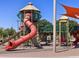 Community playground featuring slides, climbing structures, and sun shades for safety at 327 S San Fernando Ln, Casa Grande, AZ 85194