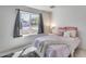 Bright bedroom featuring a pink patterned bedspread and a window with natural light at 3325 N Desoto St, Chandler, AZ 85224