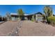 Charming single story home featuring desert landscaping, rock features, and two car garage at 3325 N Desoto St, Chandler, AZ 85224