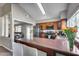 Open kitchen with stainless steel appliances, a breakfast bar and cherry-colored countertops at 3325 N Desoto St, Chandler, AZ 85224