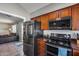 Open kitchen featuring stainless steel appliances and cherry-colored cabinets at 3325 N Desoto St, Chandler, AZ 85224