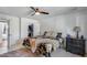 Spacious bedroom with patterned bedspread, fan, and closet with an organization system at 3325 N Desoto St, Chandler, AZ 85224
