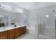 Bright bathroom with double sink vanity, garden tub, and glass enclosed shower at 3336 E Thornton Ave, Gilbert, AZ 85297