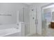 Bathroom featuring a glass enclosed shower and separate soaking tub at 3336 E Thornton Ave, Gilbert, AZ 85297