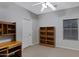 Bedroom featuring soft carpet, a ceiling fan, and a built-in desk, creating a functional and inviting space at 3336 E Thornton Ave, Gilbert, AZ 85297