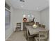 Bright dining room featuring a wooden table, large window, and modern decor for elegant gatherings at 3336 E Thornton Ave, Gilbert, AZ 85297