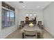 Well-lit dining room with a wooden table, large window, and decorative elements for a welcoming atmosphere at 3336 E Thornton Ave, Gilbert, AZ 85297