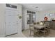 Inviting dining room featuring a neutral color palette, a modern light fixture, and an adjacent living space at 3336 E Thornton Ave, Gilbert, AZ 85297