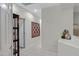 Hallway with tile flooring, neutral walls, and decorative tapestry, exuding a warm and inviting ambiance at 3336 E Thornton Ave, Gilbert, AZ 85297