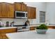 Bright kitchen with stainless steel appliances, ample cabinet space, and light colored countertops at 3336 E Thornton Ave, Gilbert, AZ 85297