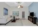 Bright living space with a comfortable couch, dark wood coffee table, and outside access at 3336 E Thornton Ave, Gilbert, AZ 85297