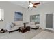 Comfortable living area with a light couch, a dark wood coffee table, and a view of the back entrance at 3336 E Thornton Ave, Gilbert, AZ 85297