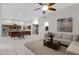 Bright living room with a ceiling fan, comfortable seating, and an open view to the kitchen area at 3336 E Thornton Ave, Gilbert, AZ 85297